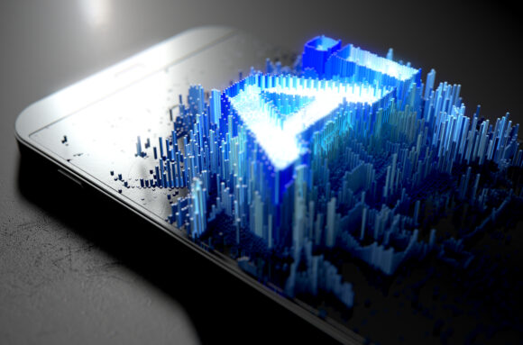 A microscopic closeup concept of small cubes in a random layout that build up to form the word artificial intelligence illuminated on a generic smartphone - 3D render